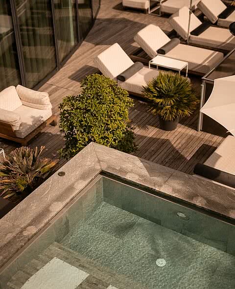 Pool mit Liegen im Wellnesshotel Sonnen Resort Naturns in Südtirol