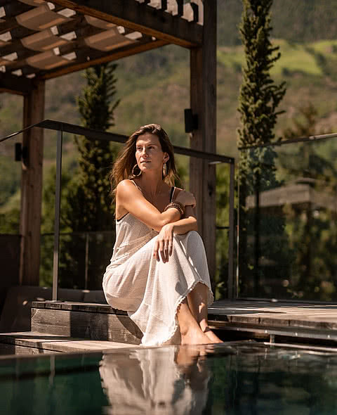 Frau am Außenpool im Wellnesshotel Sonnen Resort in Naturns Südtirol