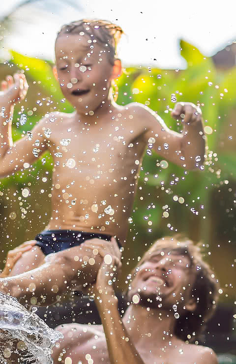 Dad and son have fun in the pool.
