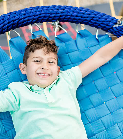 Kind liegt auf Trampolin im Familienhotel Sonnen Resort Naturns
